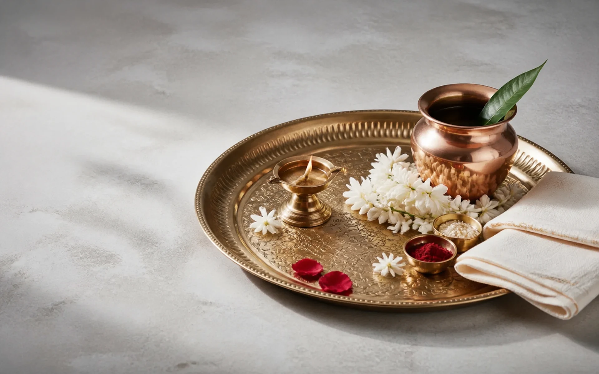 Illustration of a brass puja tray and ritual materials